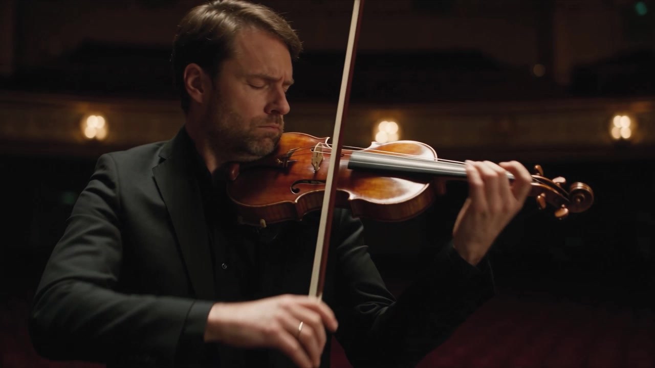 A violinist performing in a concert hall